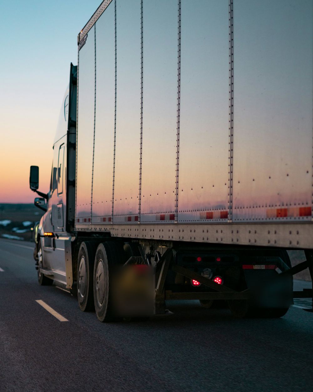 53-foot dry van trailer on the highway at sunset